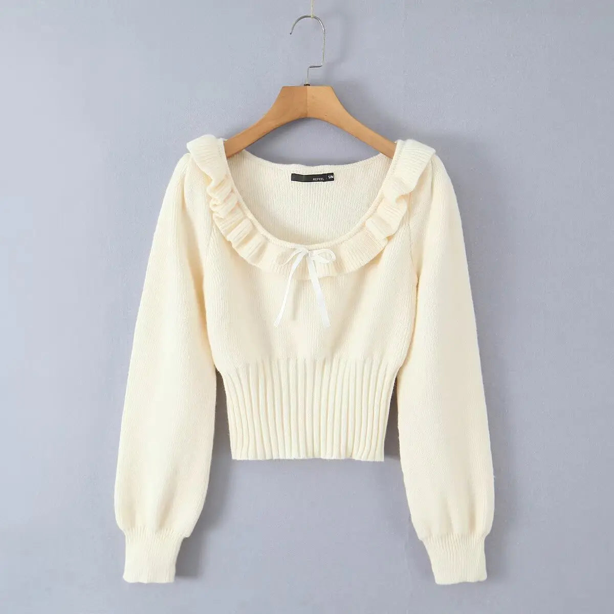 Cream ruffle trim satin bow fuzzy knit cropped sweater, hanger front