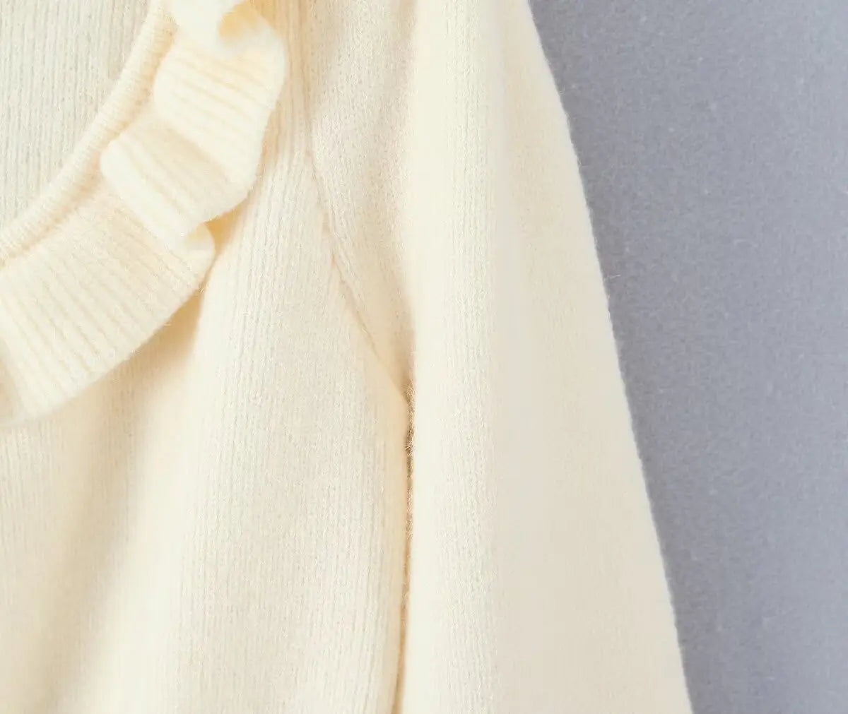 Close-up of shoulder seam and fuzzy knit sleeve
