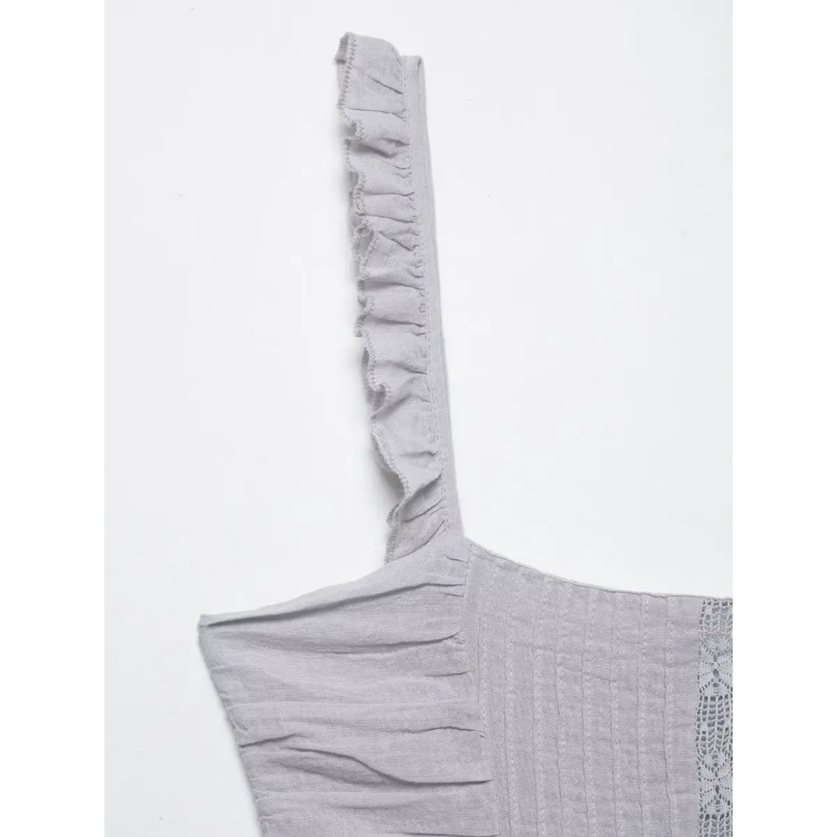 Close-up of the ruffled cami strap on a gray dress, highlighting the delicate frill and stitching.