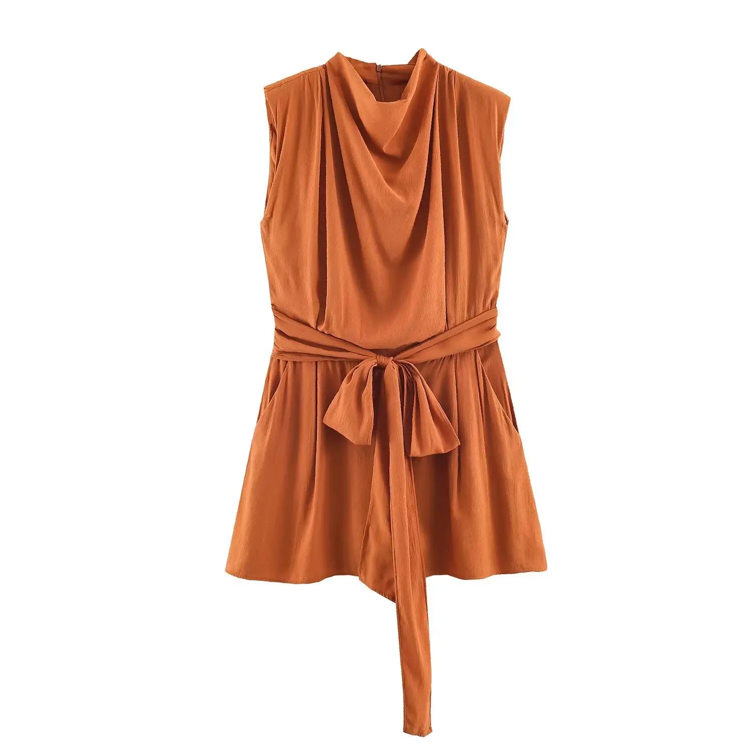 Studio white background full front shot of rust brown cowl neck sleeveless romper, self fabric wrap tie belt, side pockets, lightweight textured woven fabric