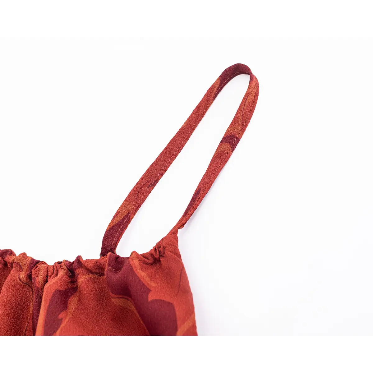 Close-up of solid terracotta full inner lining under printed outer chiffon fabric.