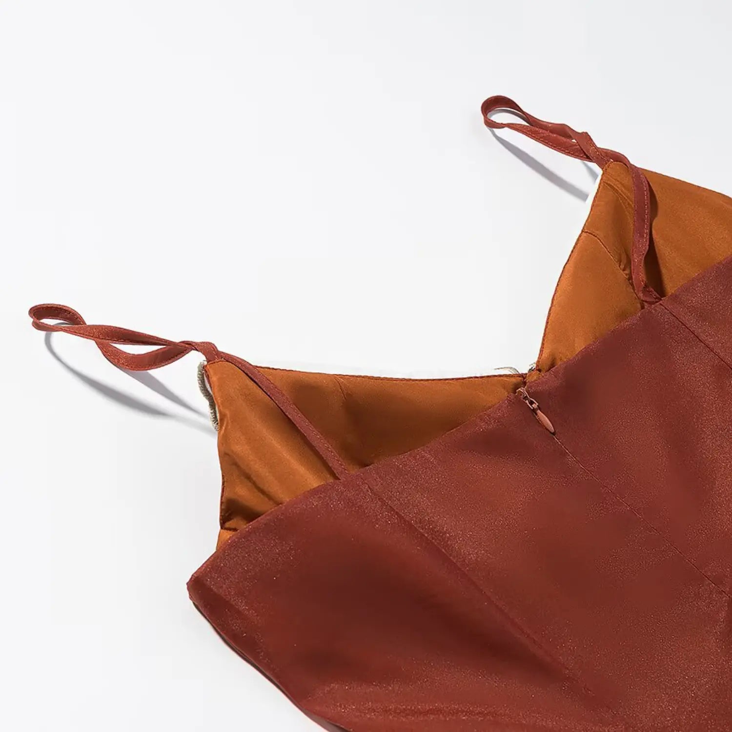 Flat lay close‑up of back invisible zipper and adjustable camisole straps