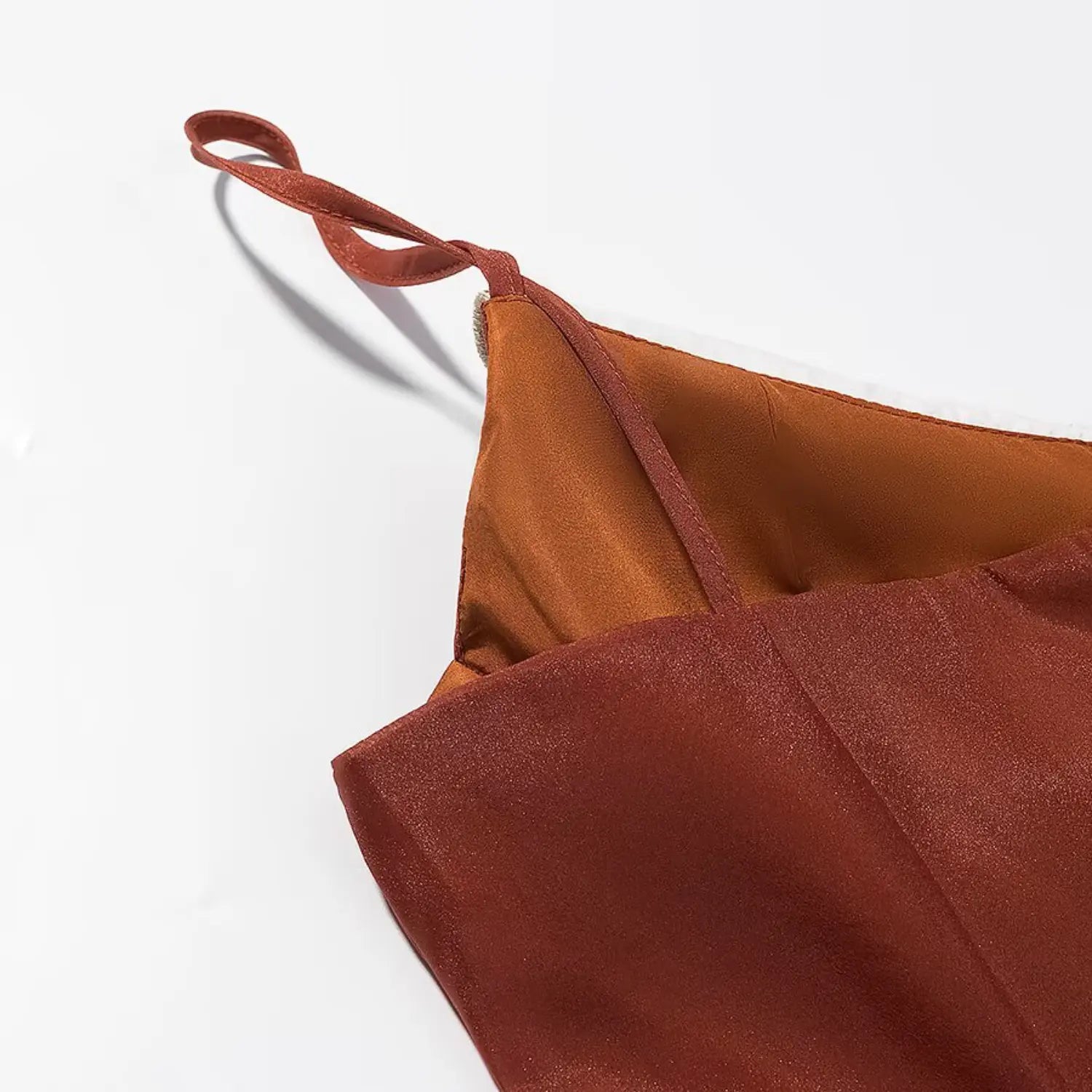Extreme close‑up of adjustable spaghetti strap stitching and inner lining edge