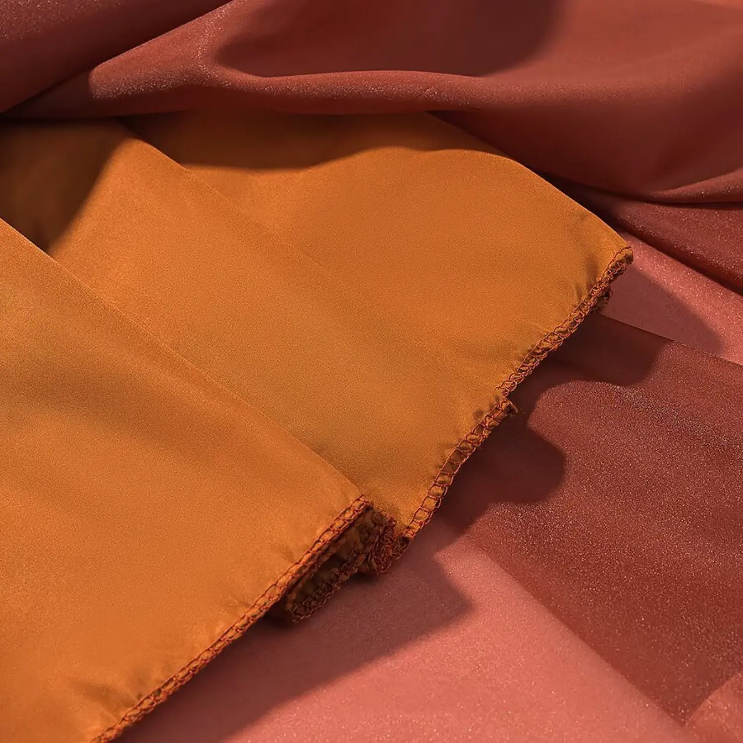 Close‑up shot of warm orange inner lining fabric and neat stitched hem