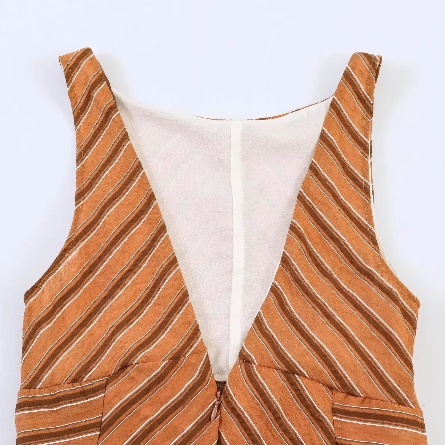 Close up of rust chevron stripe maxi dress deep v back with invisible zipper, lined interior