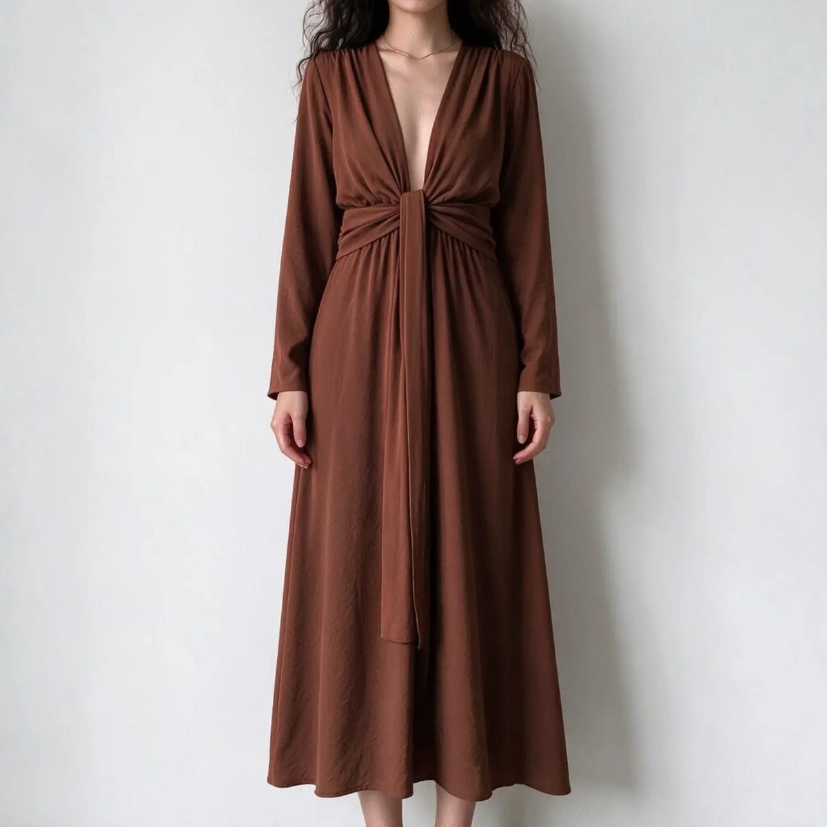 Model wearing rust tie waist surplice midi dress, front view