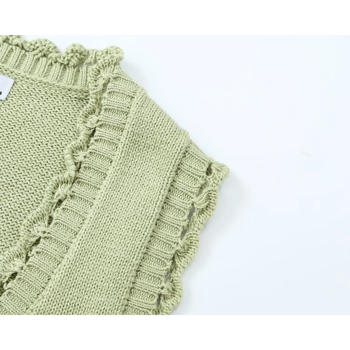 Close-up of armhole with openwork scalloped crochet edge
