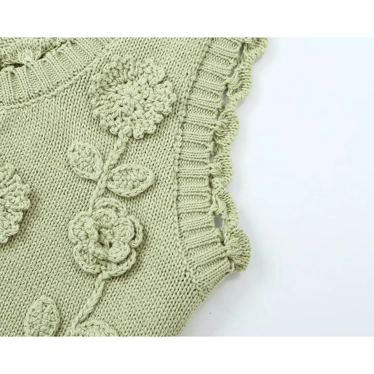 Close-up of three-dimensional crochet flower and leaf applique