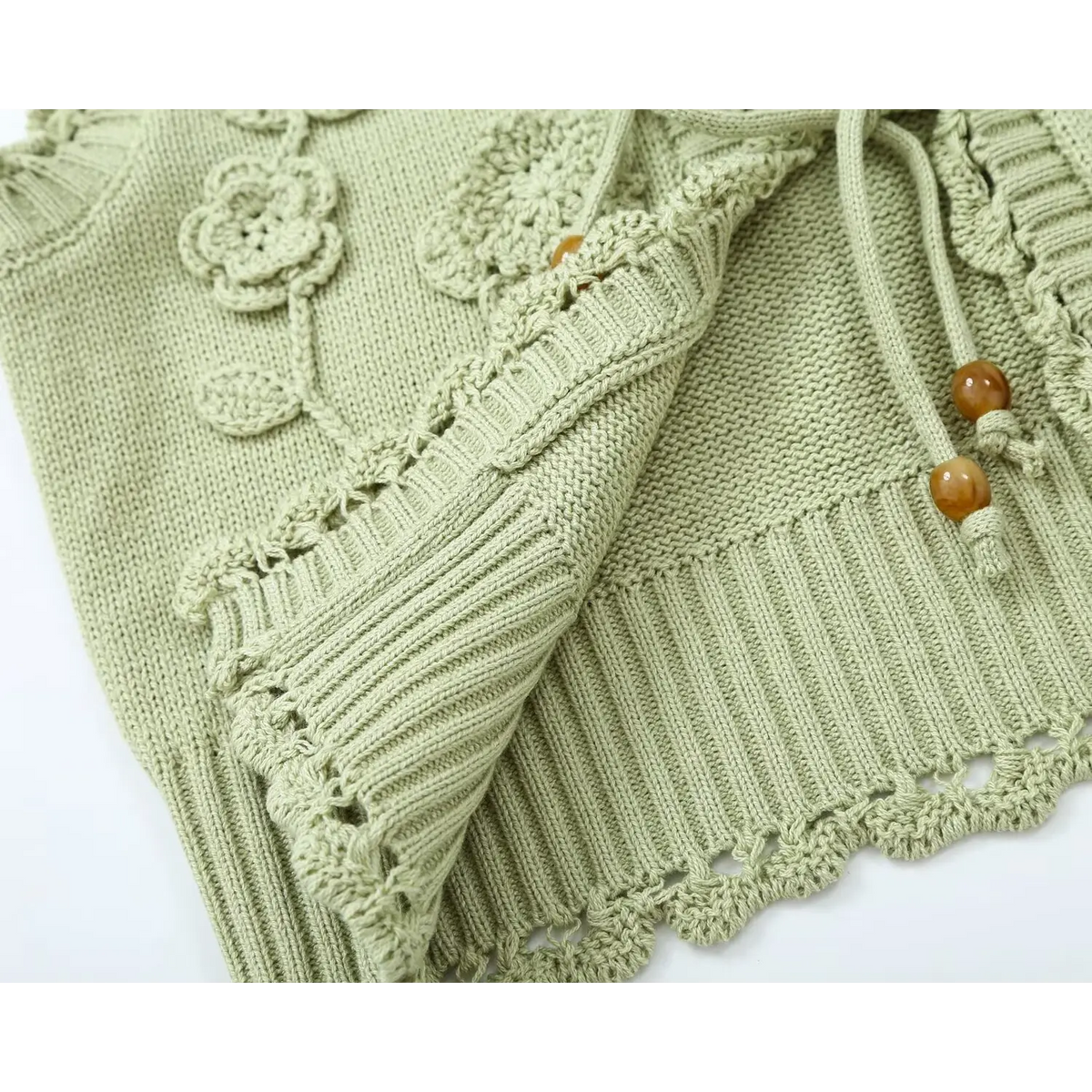 Close-up of folded ribbed hem showing tie cord and beads