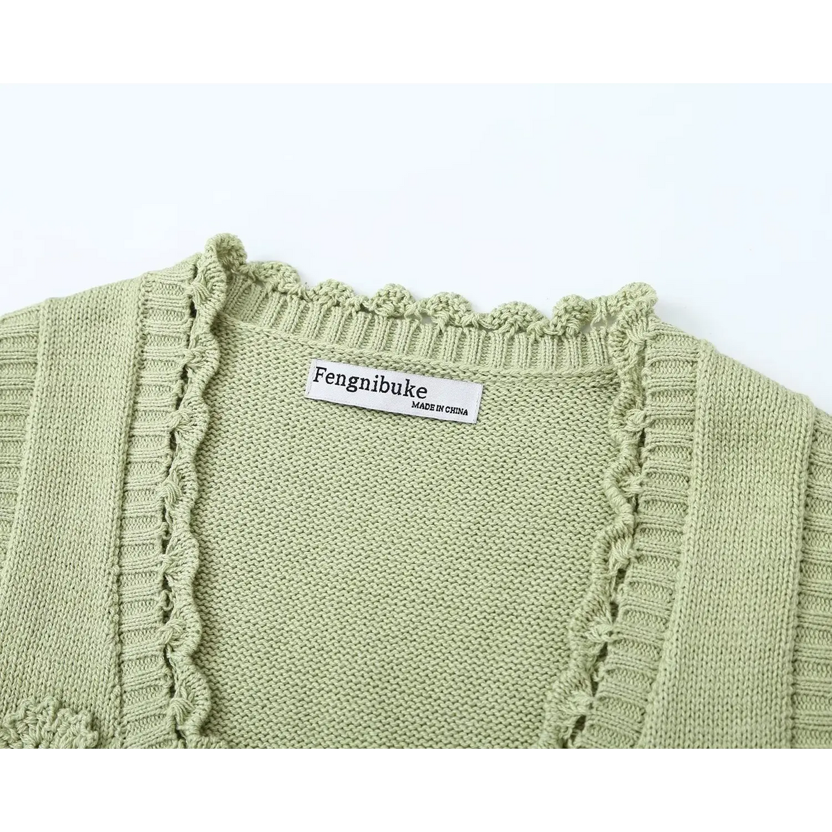 Close-up of back neckline, brand label and scalloped collar trim