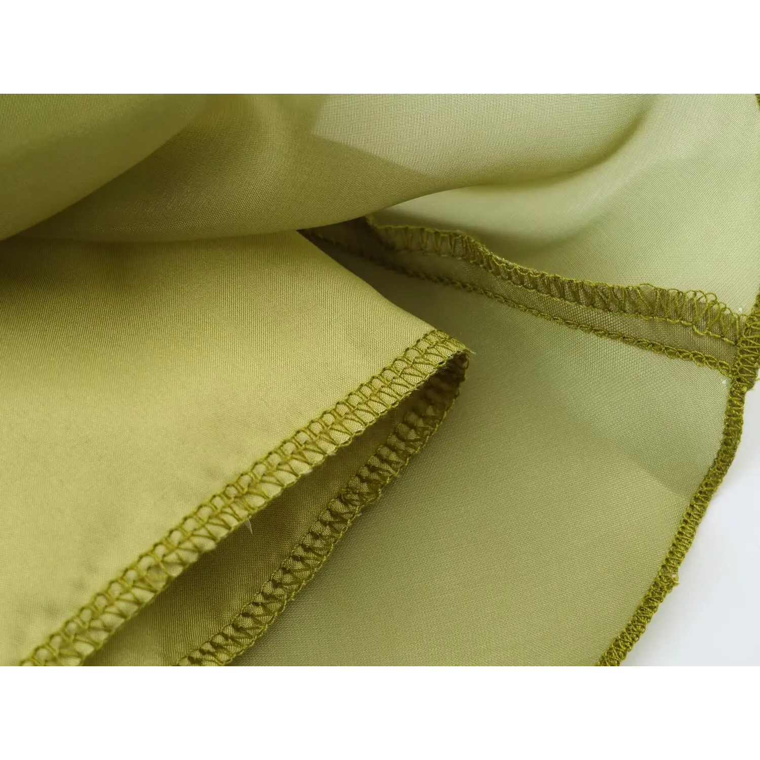 Folded fabric shot showing outer organza and inner lining, finished hem construction