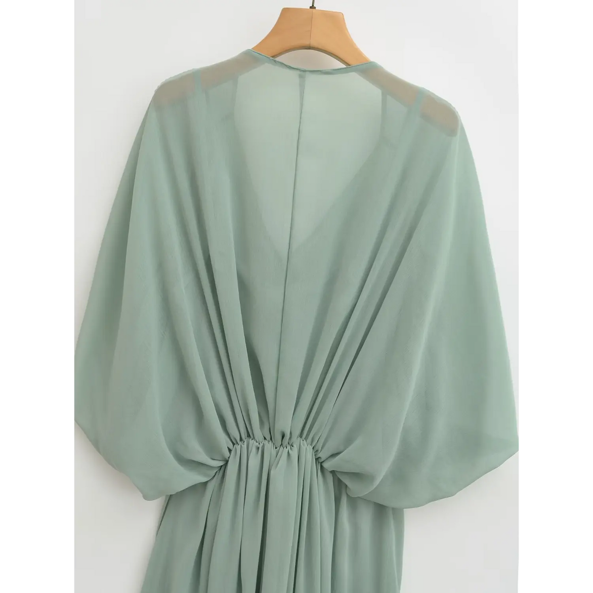 Back view of outer dress on hanger