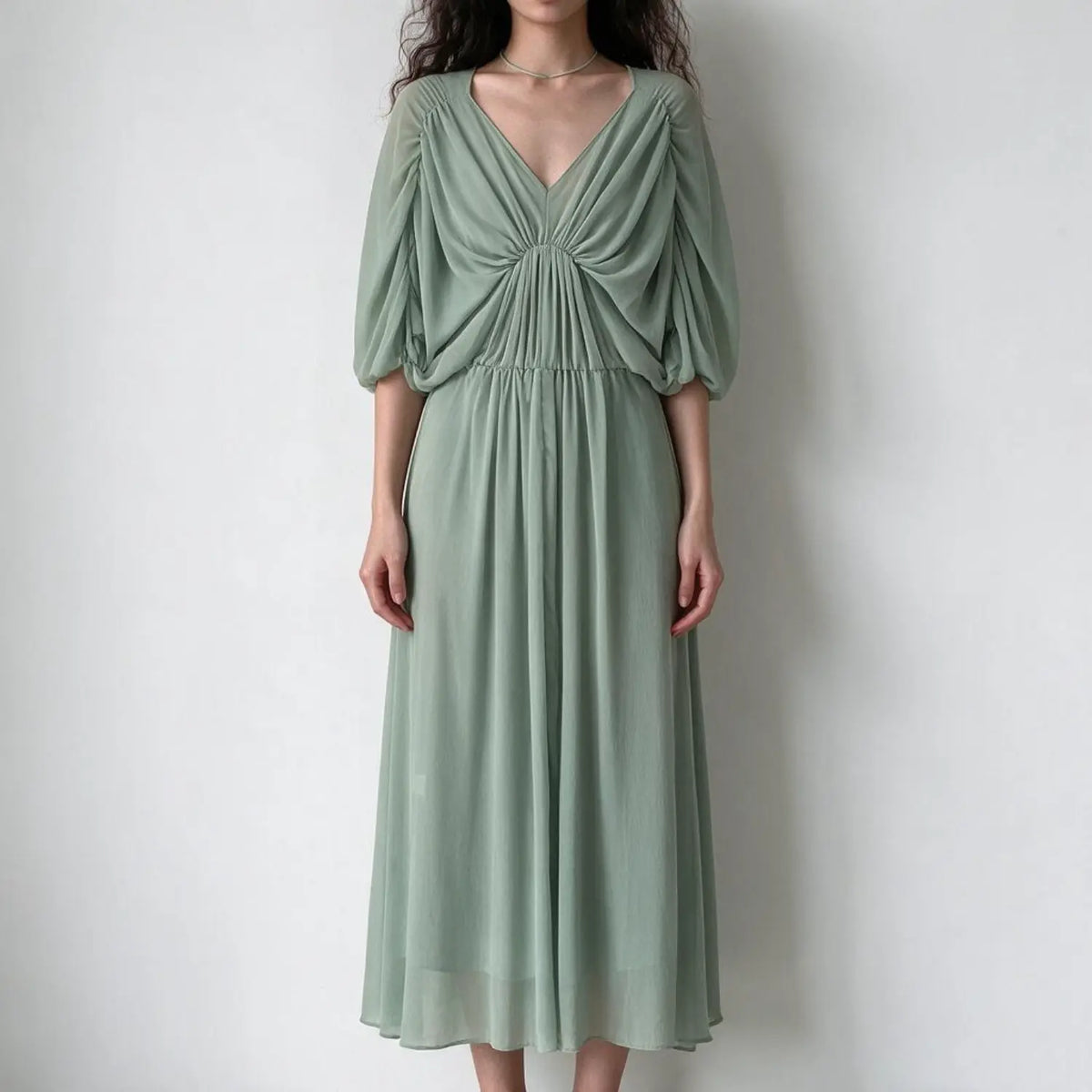 Model wearing sage green gathered bust slip midi dress, front view