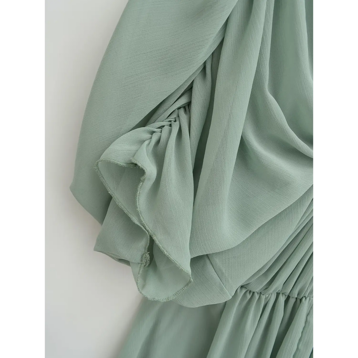 Close-up of dolman sleeve opening and hem stitching