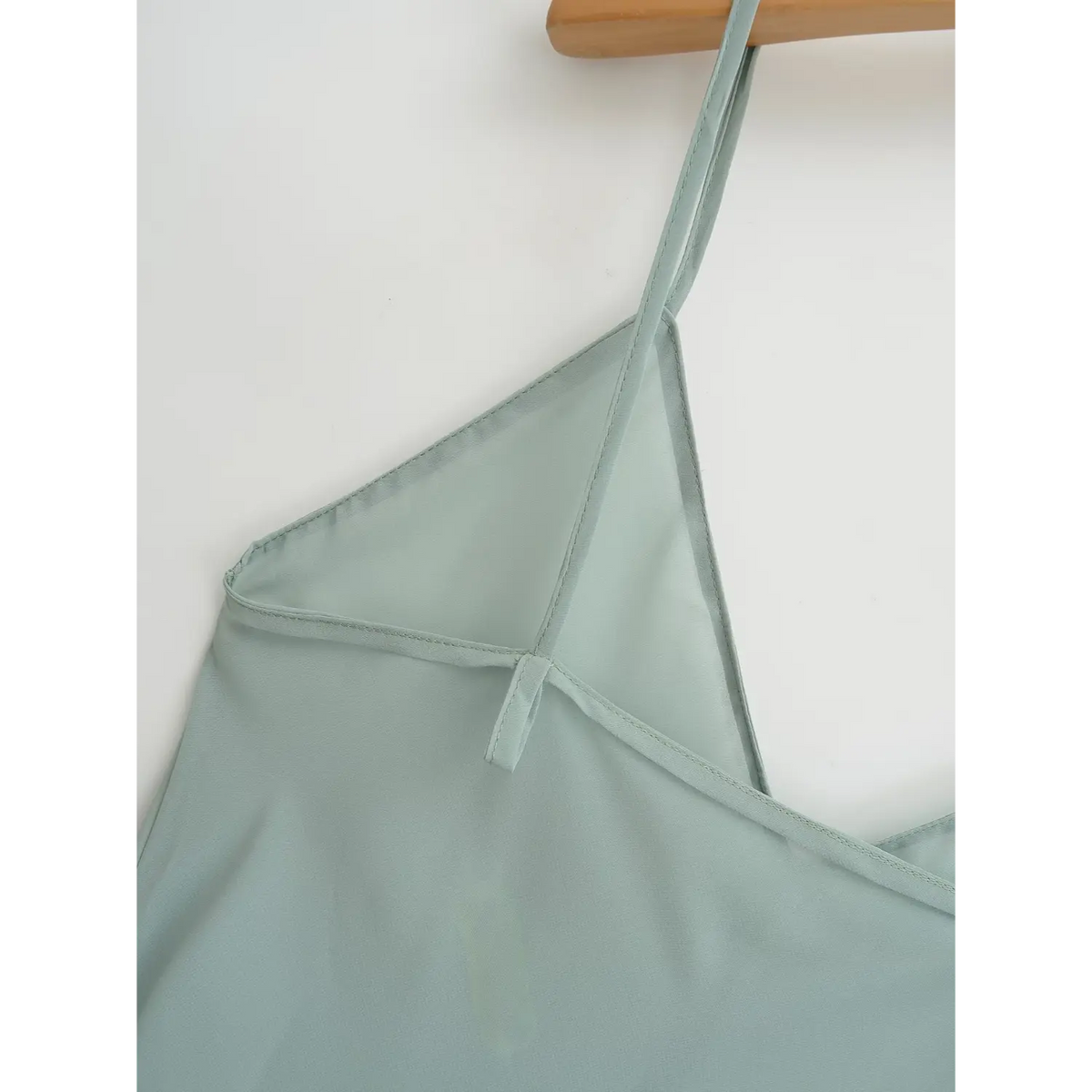 Close-up of slip dress thin strap attachment