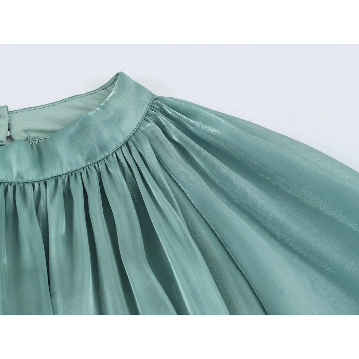 Close-up of neck pleats and shoulder