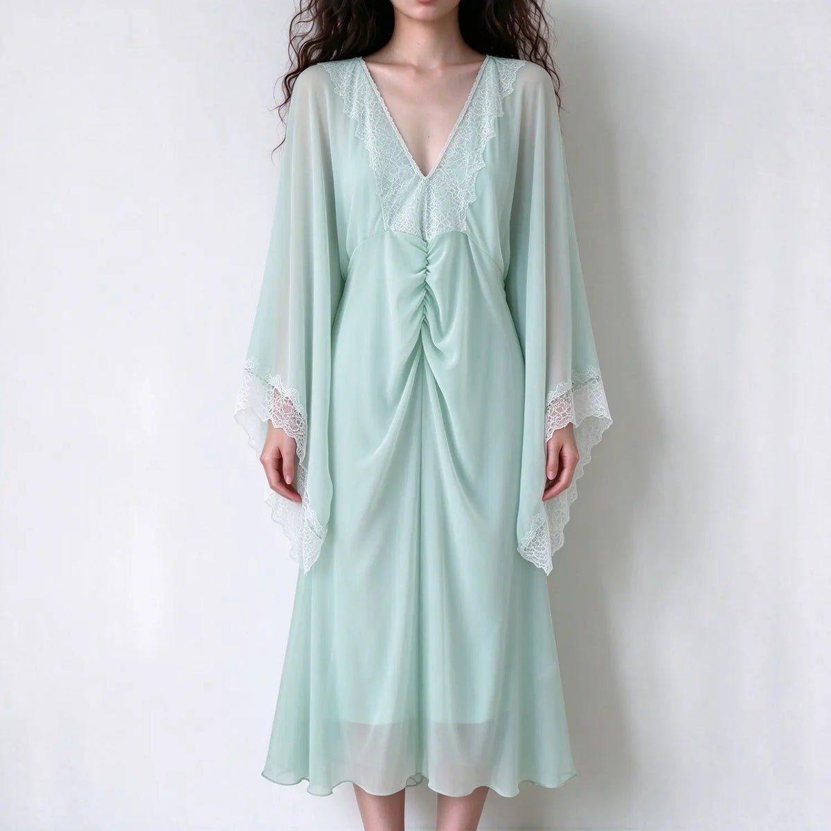 Model wearing sage green lace trim cape sleeve midi dress, front view