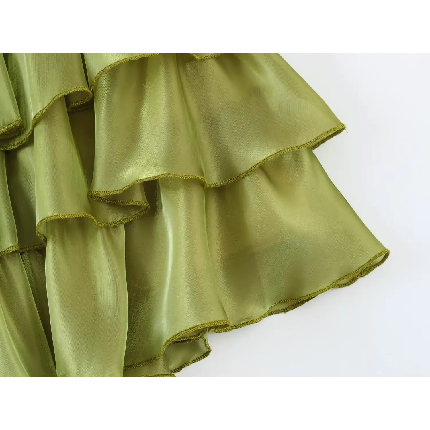 Detail shot overlapping ruffle tiers, lightweight glossy sage green sheer fabric