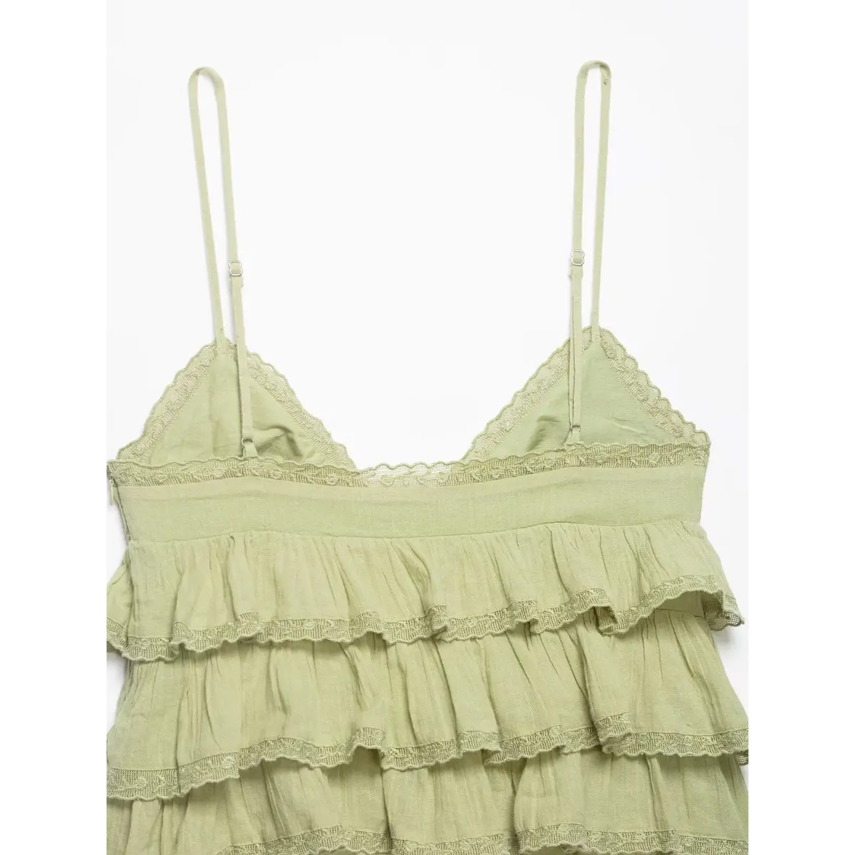 Back view of the cami top, showing the elasticated waistband, adjustable straps, and lace trim.