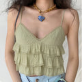 The cami top styled on a model, highlighting its layered ruffles and cropped silhouette.