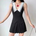 Model daily outfit shot, black sleeveless sailor mini dress, deep V white piped lapel, fitted pointed waist, bouncy box pleat skirt, styled with vintage red pendant necklace, youthful preppy campus style