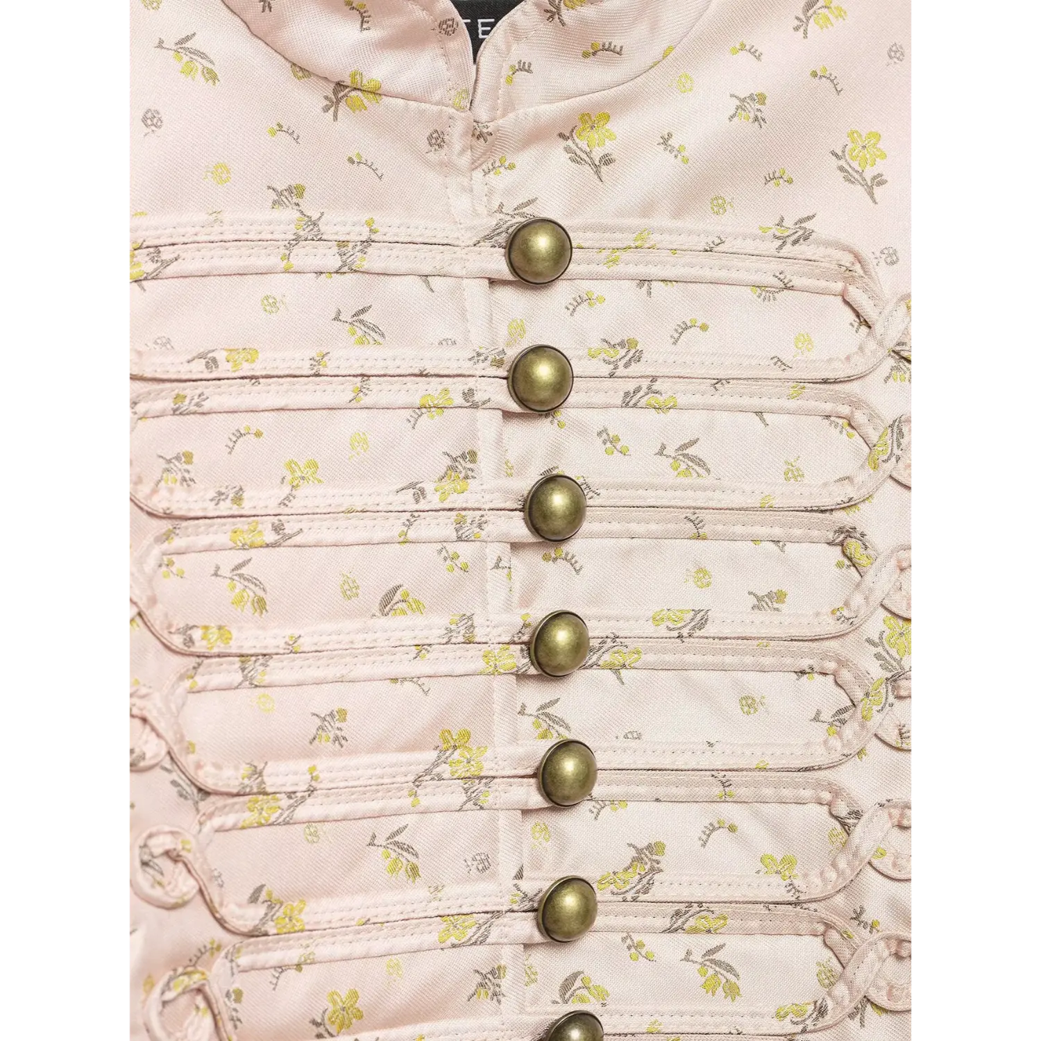 Extreme close-up front antique bronze buttons and fabric loops on pink floral satin jacket