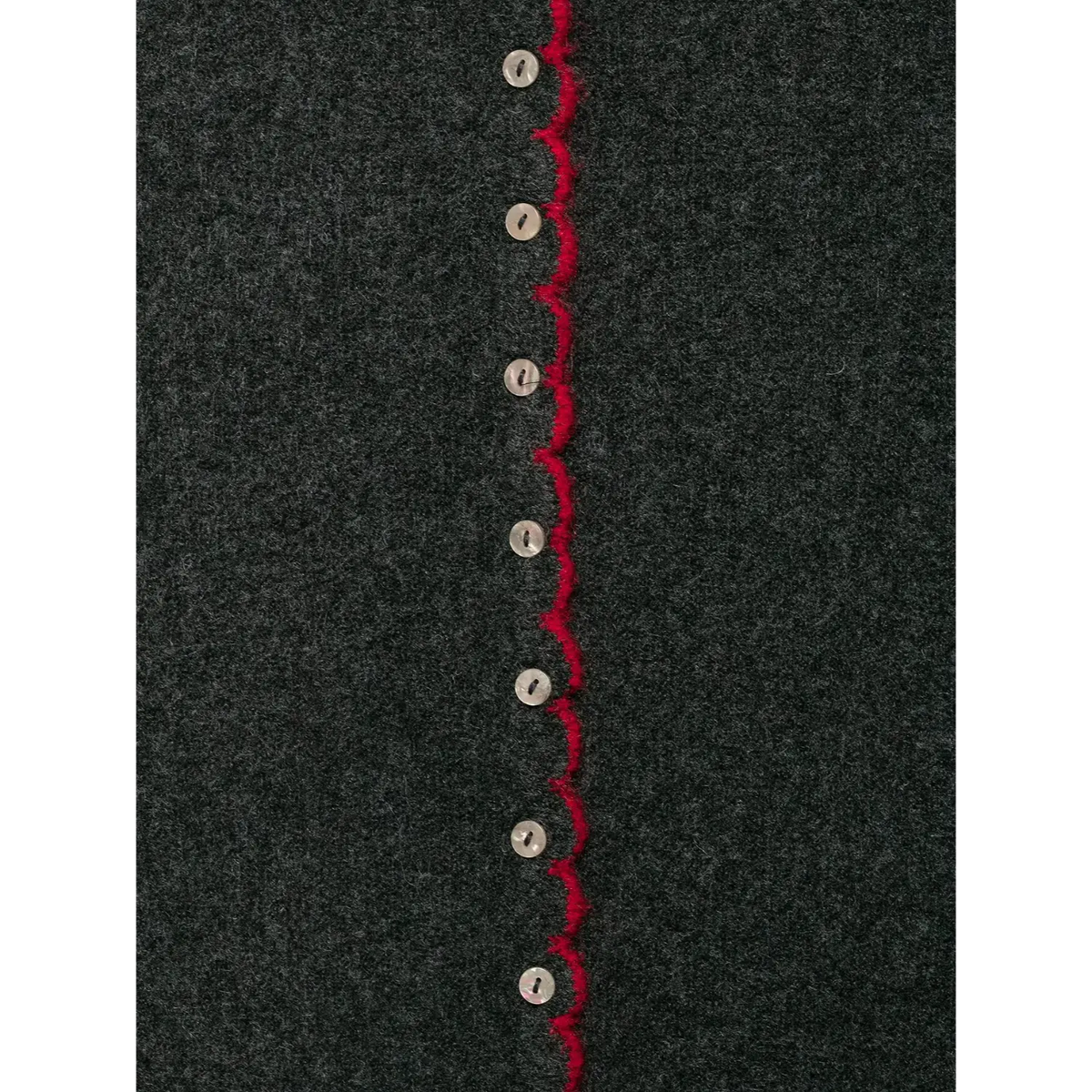 Close-up of vertical button row with red scalloped placket