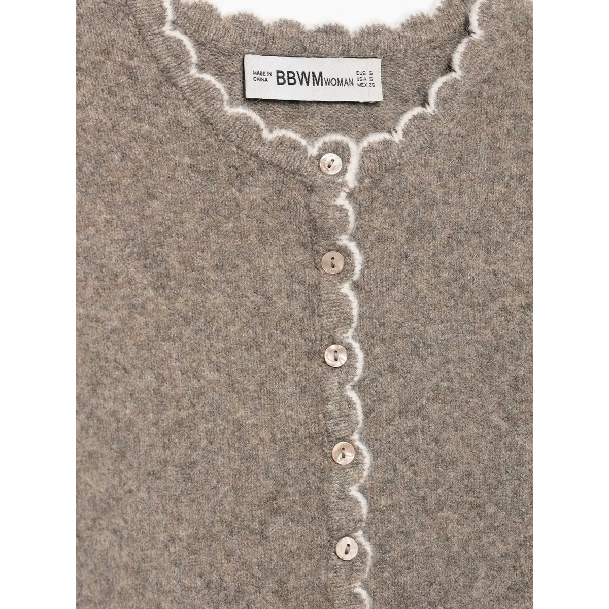 Close-up of oatmeal BBWM WOMAN label and buttons