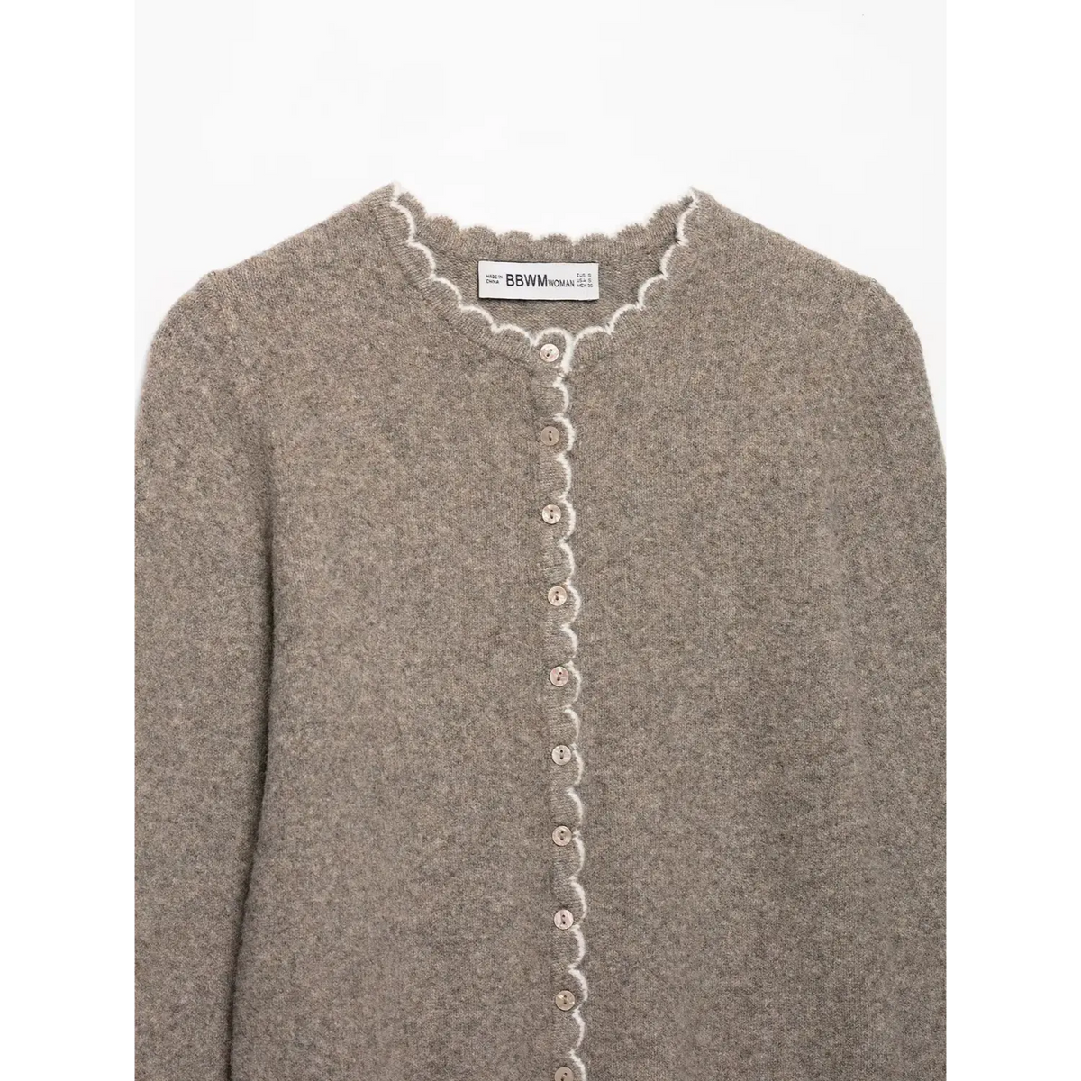 Close-up of oatmeal neckline, placket and buttons with white scallop edge