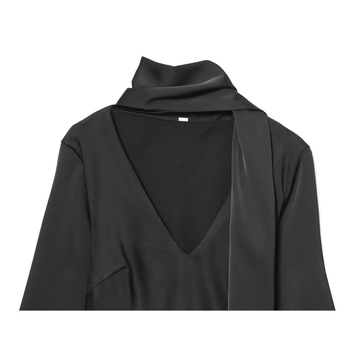 Close-up of black deep V neckline and draped scarf tie