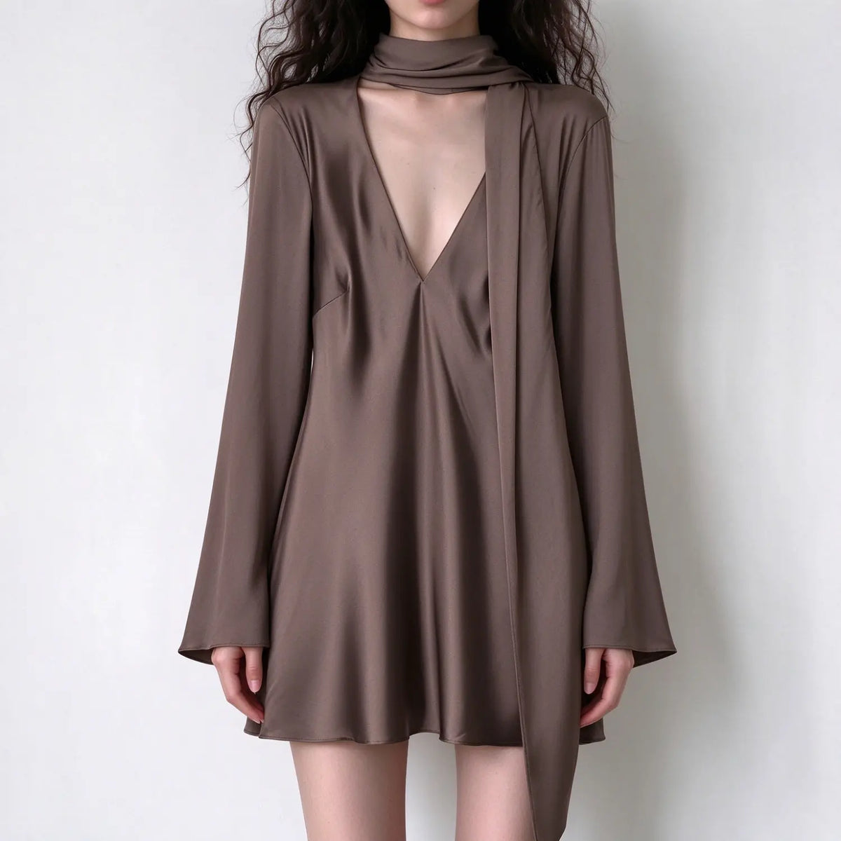 Model wearing mocha brown scarf neck deep V satin mini dress, front view