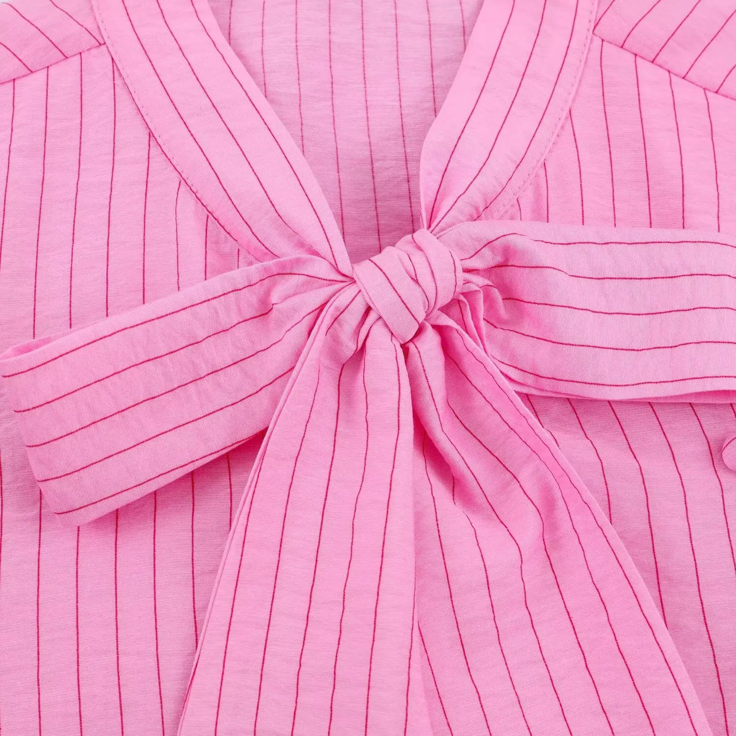 Closeup oversized bow tie fabric texture, matching pink vertical stripe
