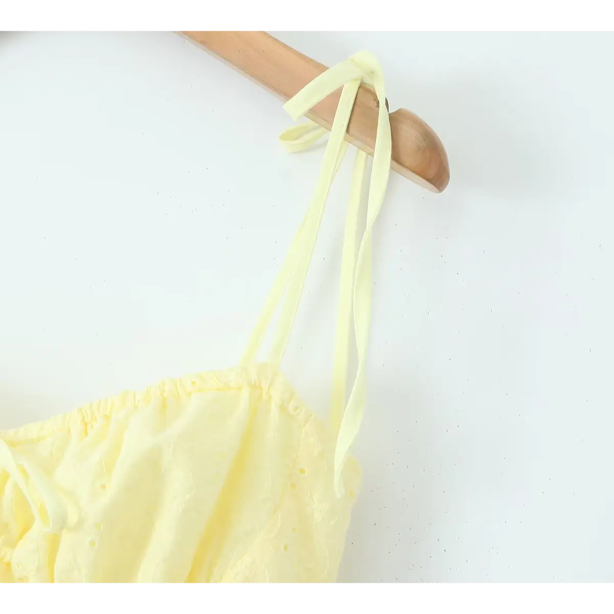 Shoulder strap detail, thin matching yellow ribbon tie design, adjustable hand-tied spaghetti straps.