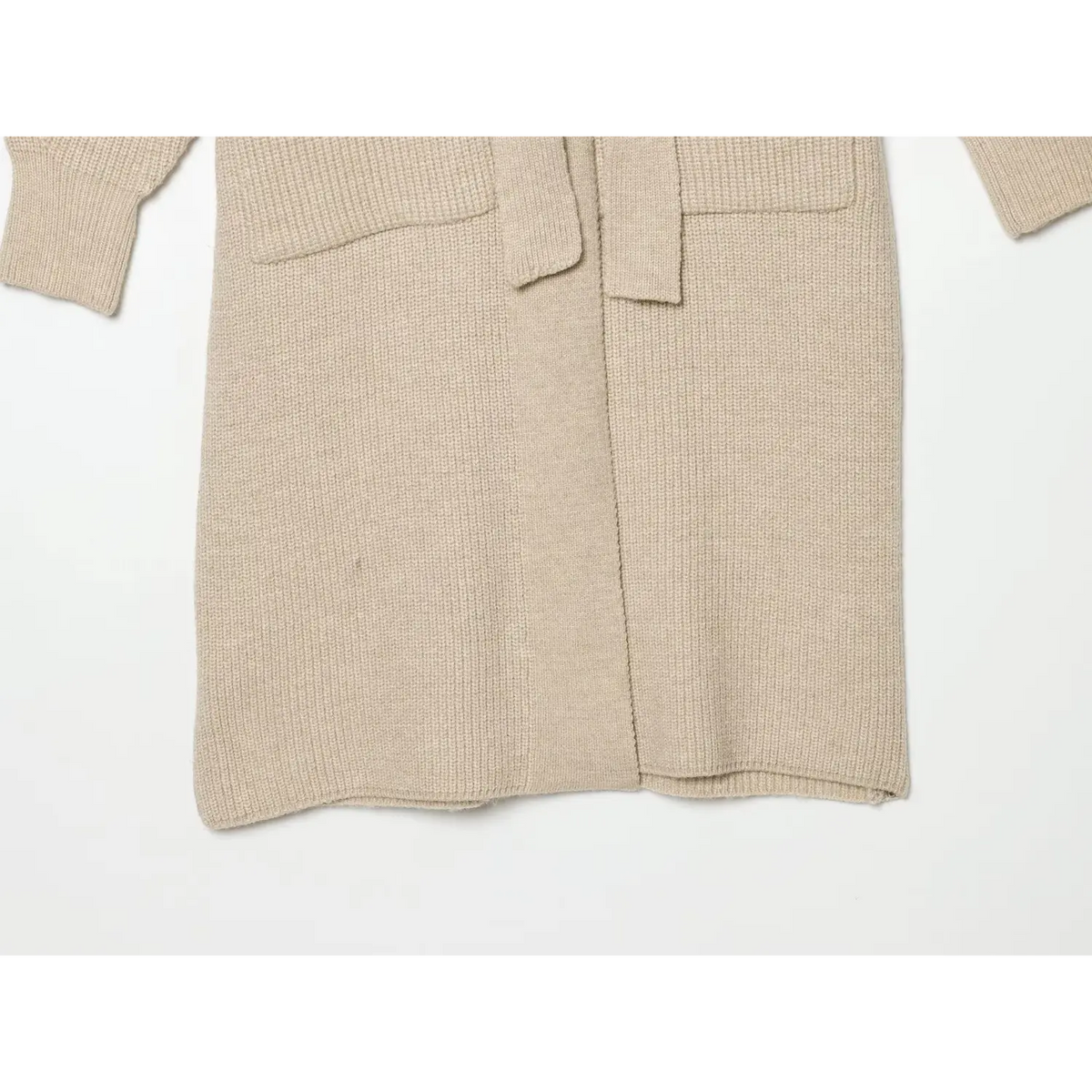 Flat lay view of beige cardigan hem, belt and patch pockets
