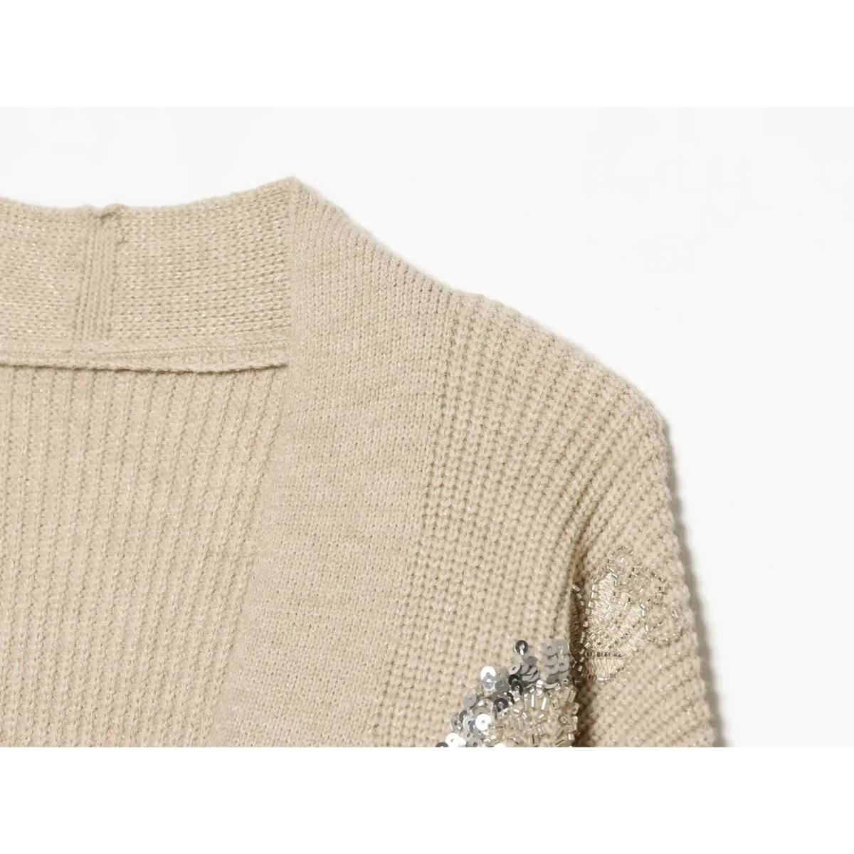 Close-up of beige back neckline, shoulder seam and sequin embroidery