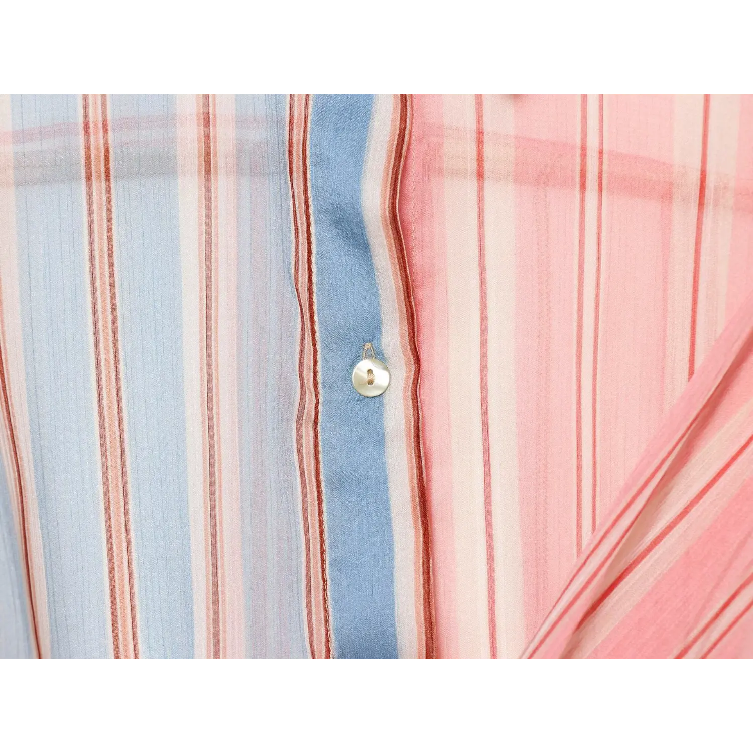 Front placket shell button macro shot, pearlescent round button, vertical blue stripe fabric background