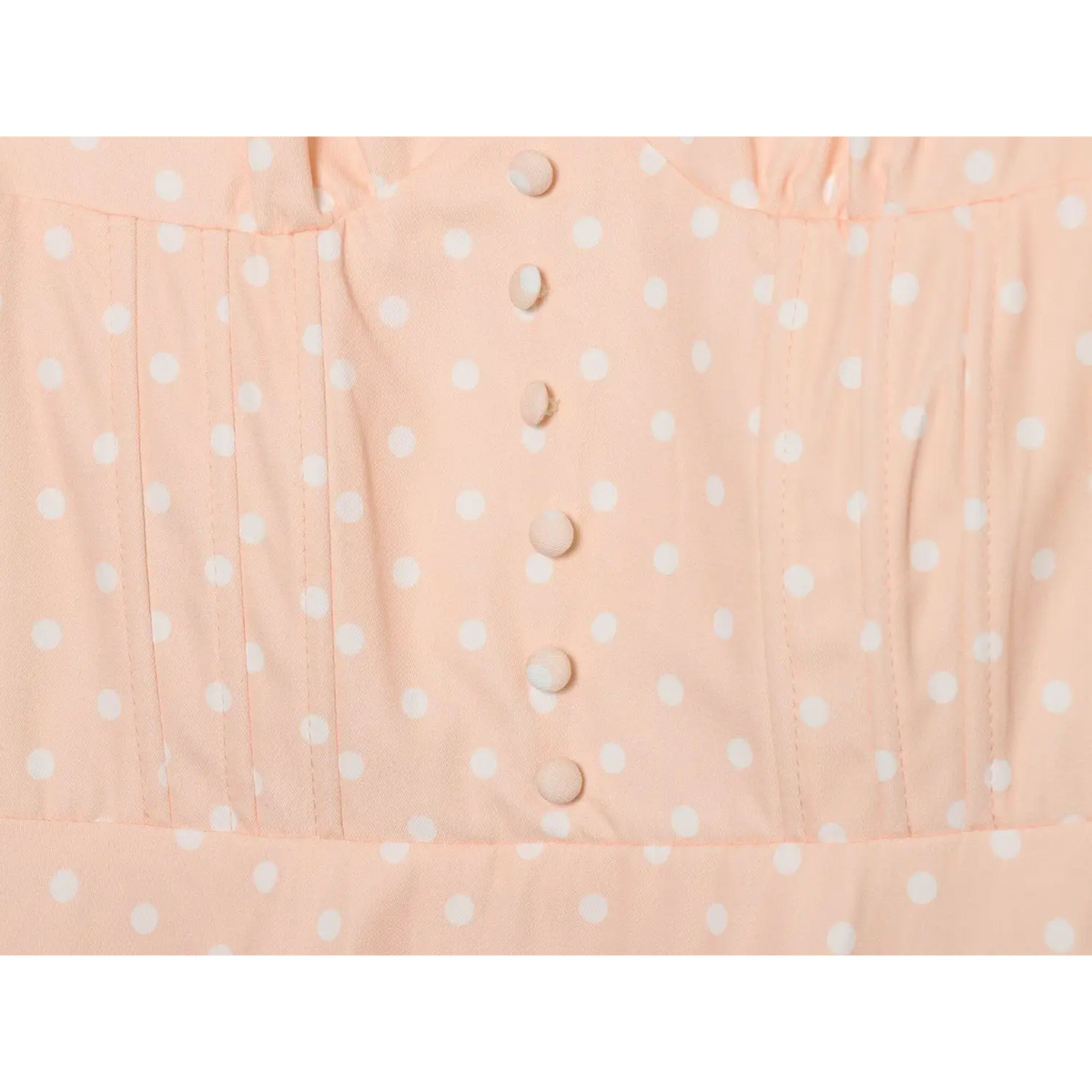 Shell pink white polka dot dress bodice close‑up,fabric covered buttons,pintuck waist stitching