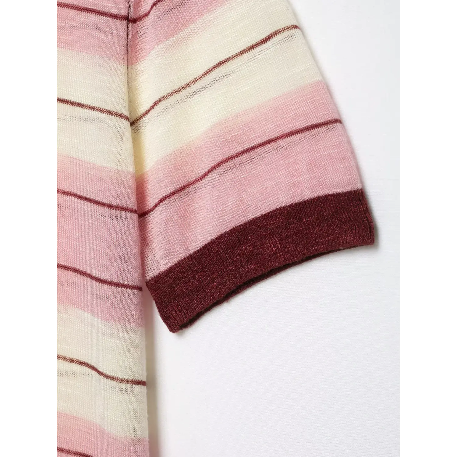 Sleeve hem close-up, solid maroon ribbed cuff, striped sheer knit, breathable thin knit structure