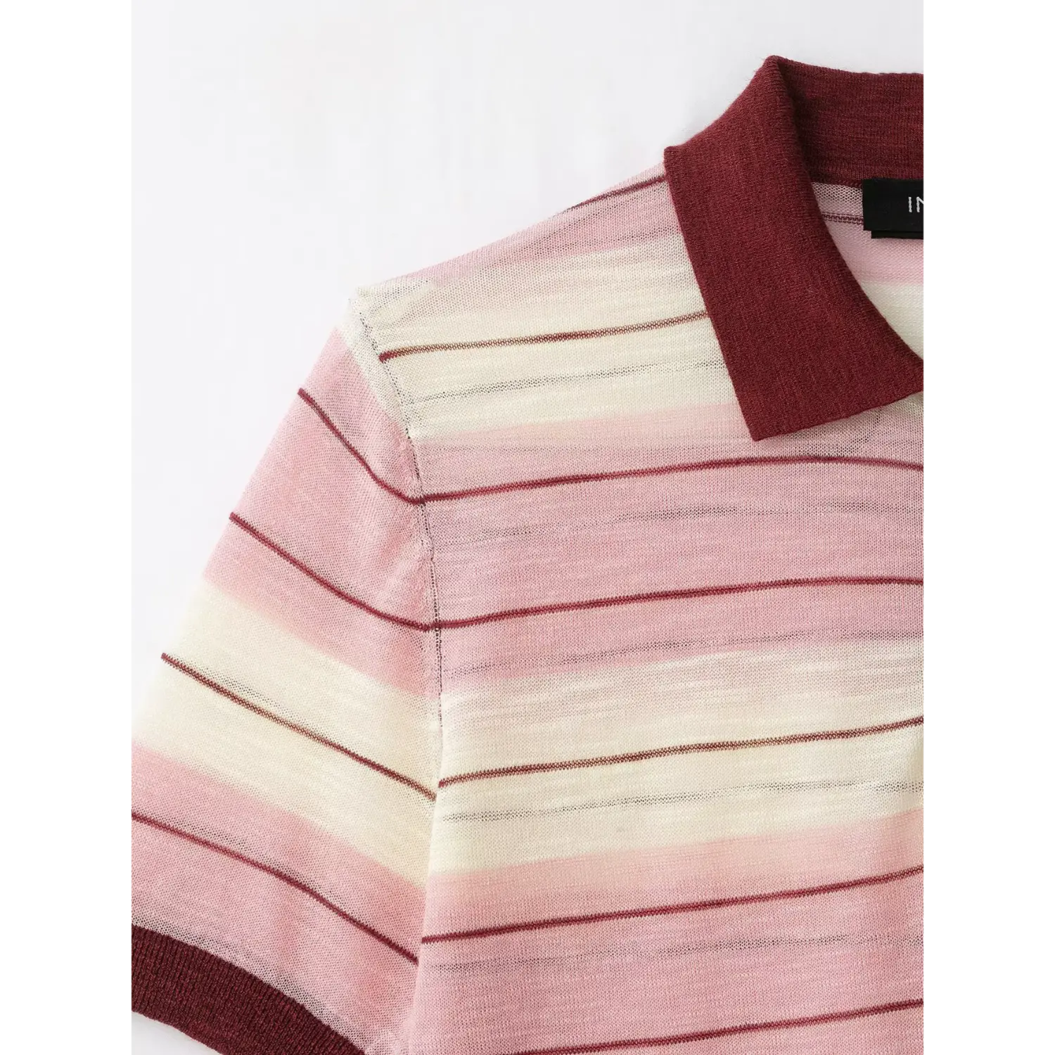 Shoulder partial view, contrast maroon polo collar, shoulder seam, pink white maroon striped sheer knit fabric