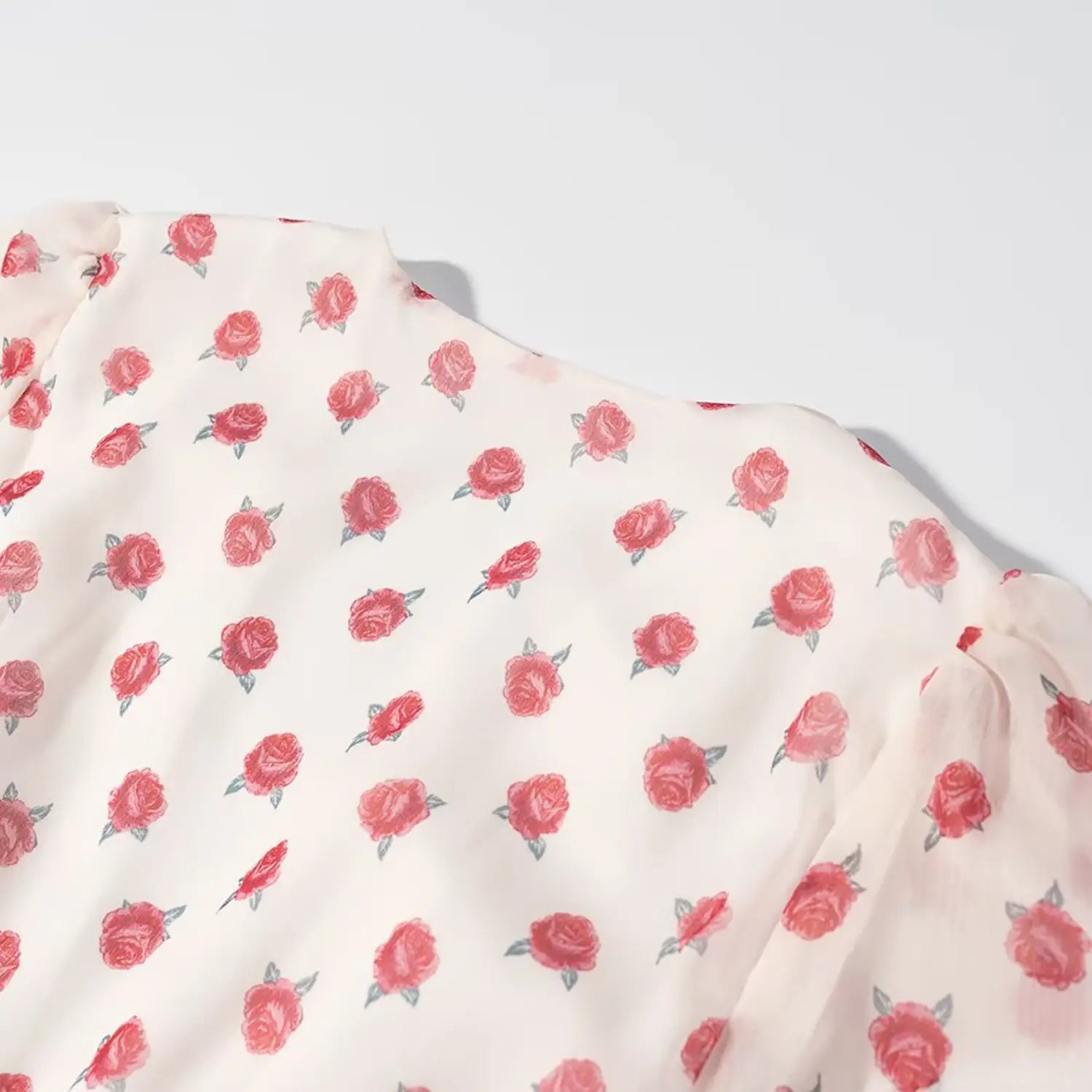 Shoulder & upper sleeve close-up, subtle puff shoulder design, tiny rose allover print sheer fabric