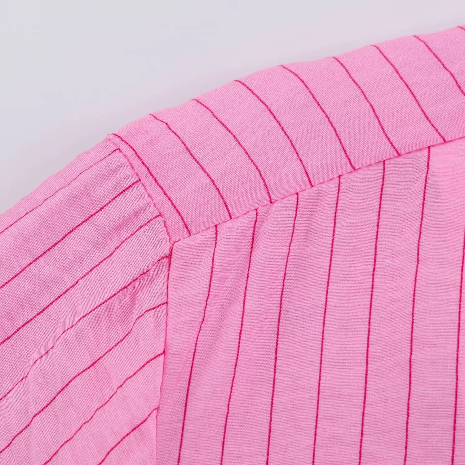 Extreme closeup shoulder yoke stitching & lightweight crinkle stripe fabric weave