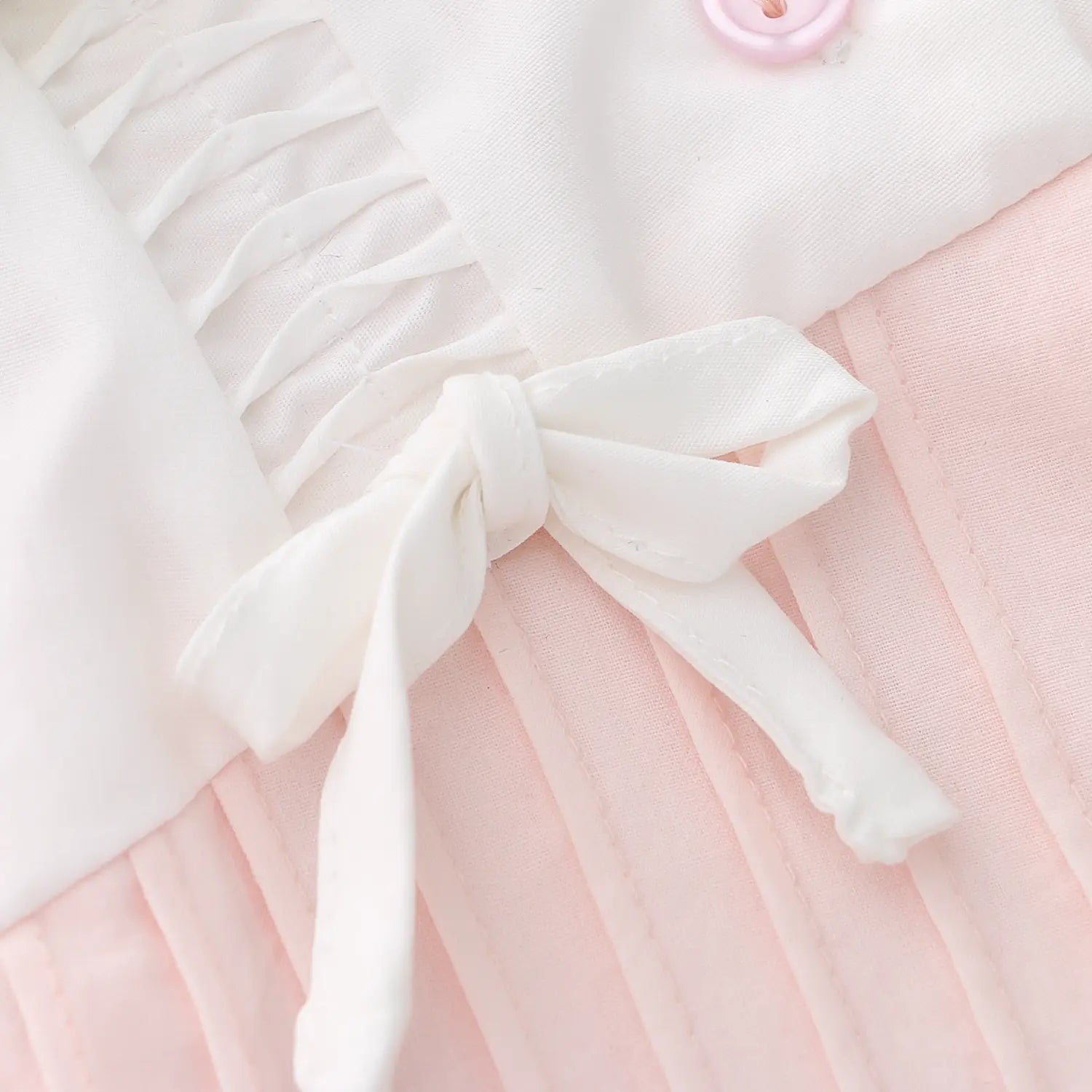 Shoulder self cotton fabric tiny bow macro close-up, lightweight soft cotton natural drape shoulder elastic shirring connect collar clean thread free sweet girl decor craft shot