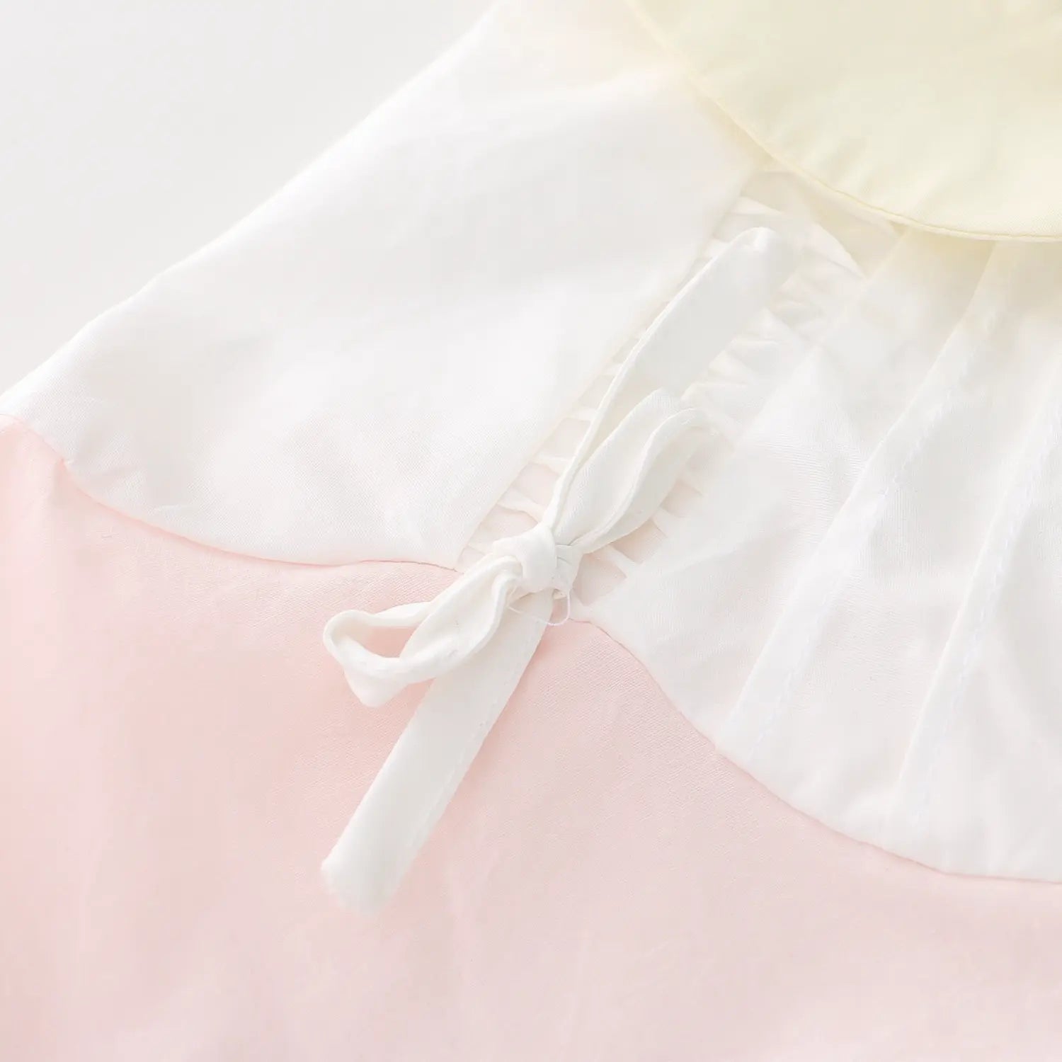 Shoulder self cotton fabric tiny bow tie macro close-up, lightweight soft cotton natural wrinkle shoulder shirring connect collar clean thread free sweet girl decor craft shot