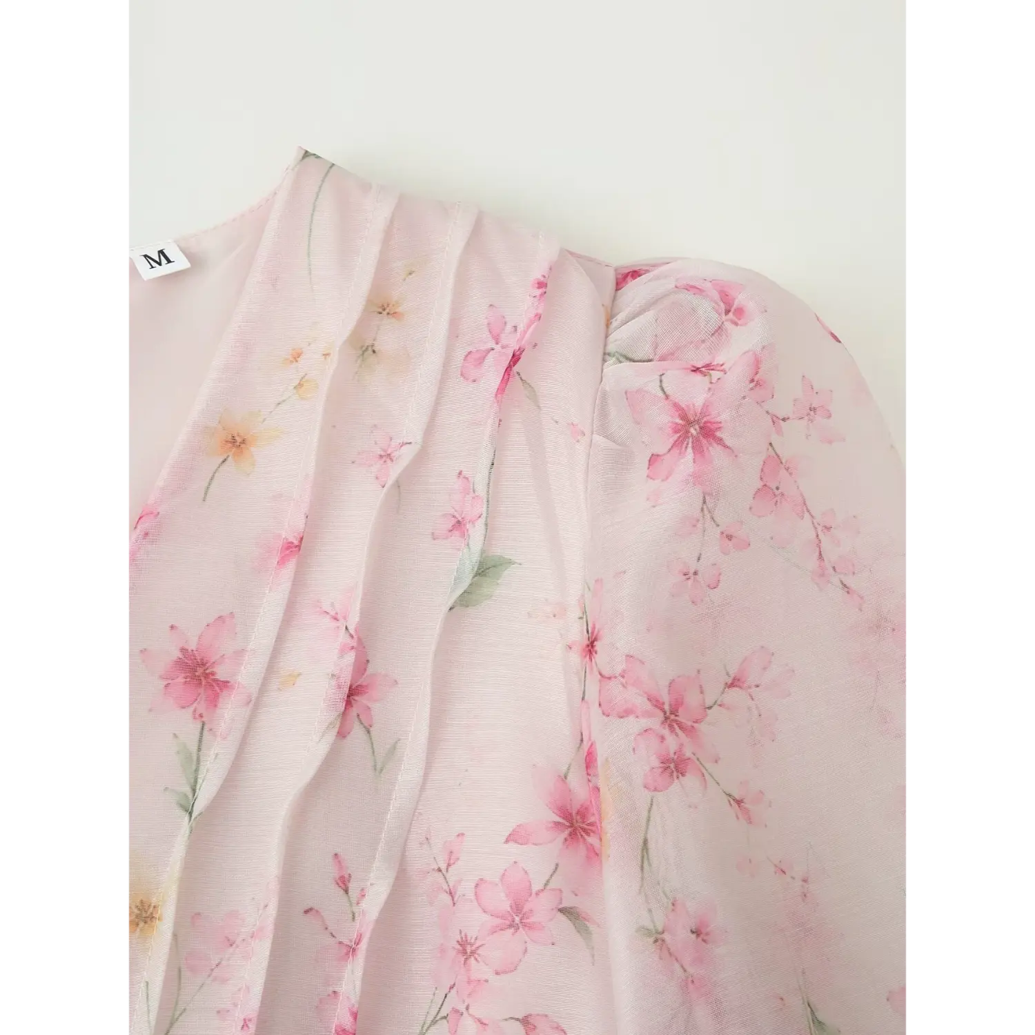 Shoulder & V-neck close-up, vertical chest pleats, puff shoulder detail, watercolor cherry blossom print chiffon
