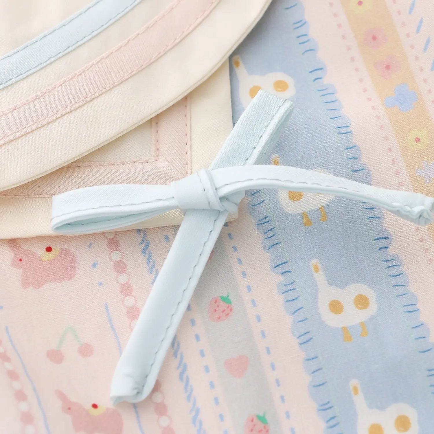 Shoulder two-tone self fabric bow macro close-up, optional light blue /pink ribbon lightweight printed cotton soft natural drape smooth shoulder collar splicing kawaii decor detail shot