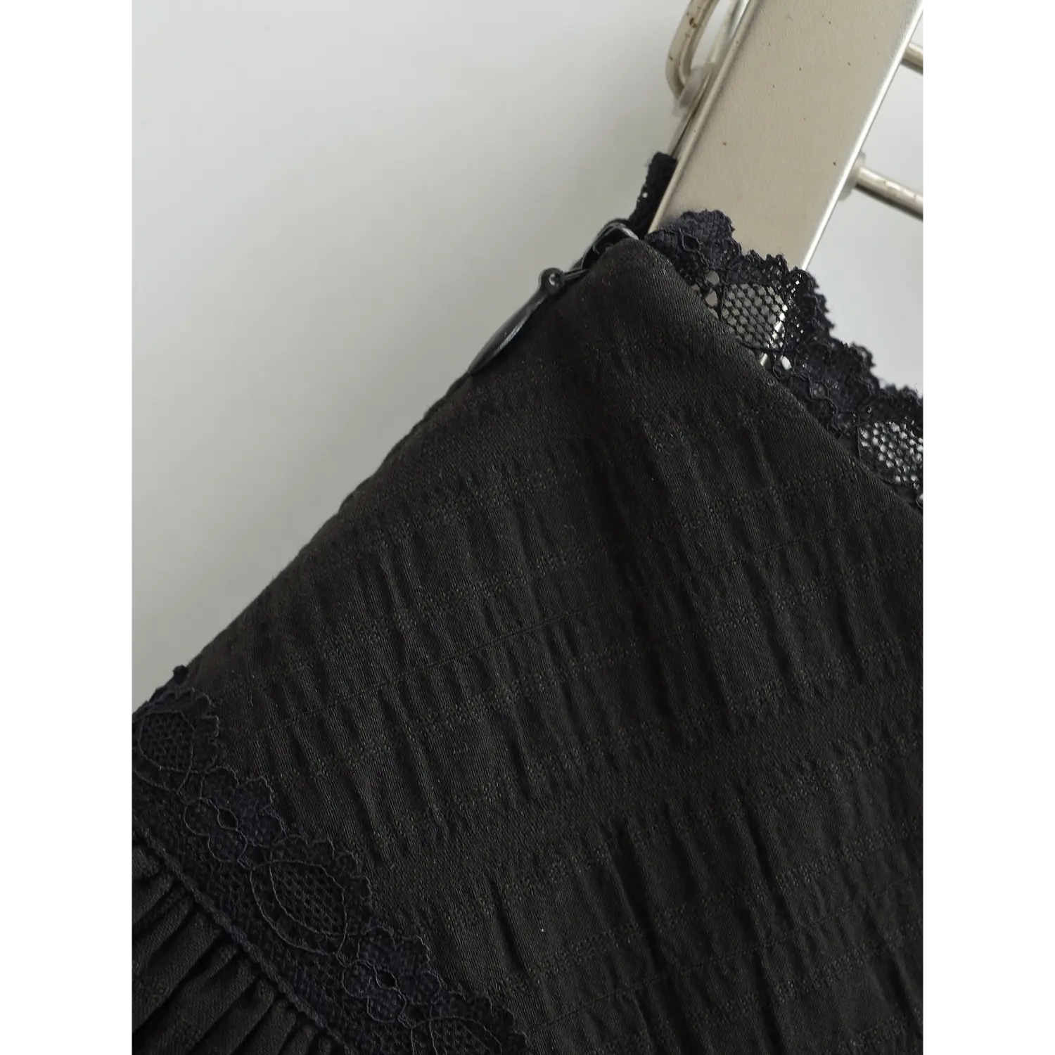 Mini skirt side black invisible zipper macro close-up, smooth sliding zipper double binding neat seam stitching easy wear sewing craft shot