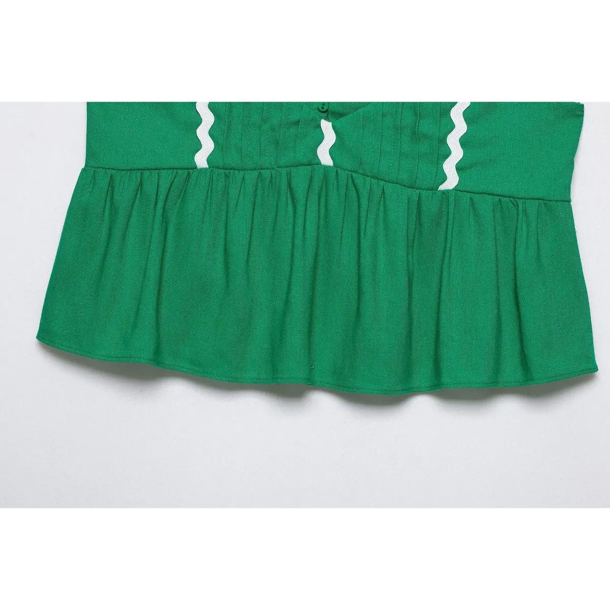 Neat side stitching between bodice and flared peplum hem