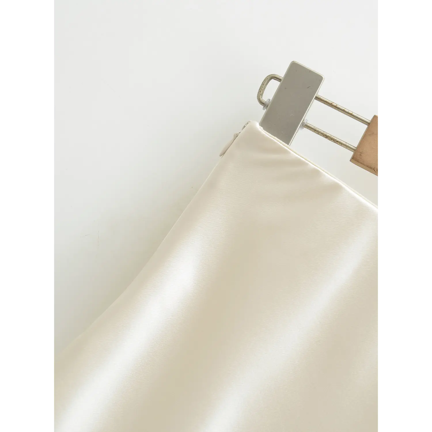 Side seam invisible zipper macro shot, fabric-wrapped matching zipper pull fully hidden inside seam double reinforced stitching, easy on & off clean minimalist design craft shot