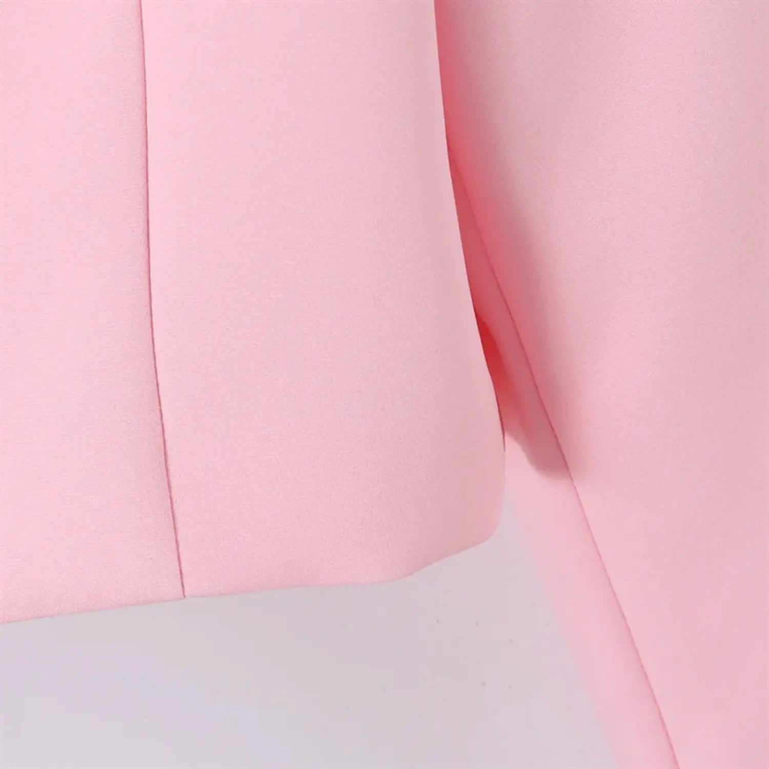 Side torso and sleeve partial view, vertical side seam, sleeve panel stitching, tailored fitted silhouette, smooth pink fabric
