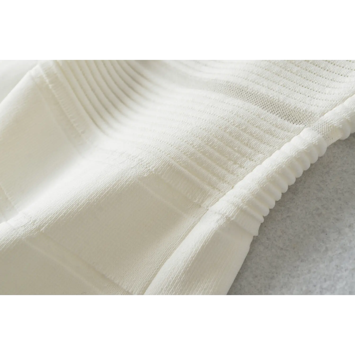 Dress side stretch knit ruche texture macro close-up, vertical rib natural elastic drape soft figure-friendly fabric touch shot